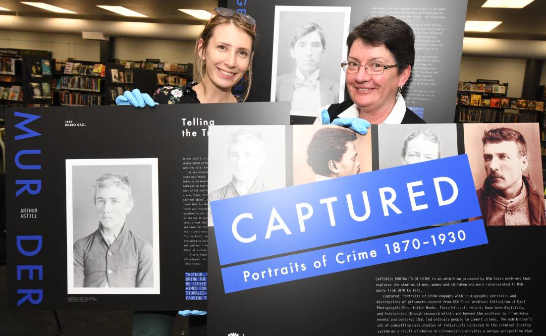 HISTORY SHOW: Bottom left: Arthur Astill was aquitted for murder after claiming he tripped on a kangaroo. Main: Rebekah Salmon and Julie Sykes set up exhibition at library. Photo: JUDE KEOGH