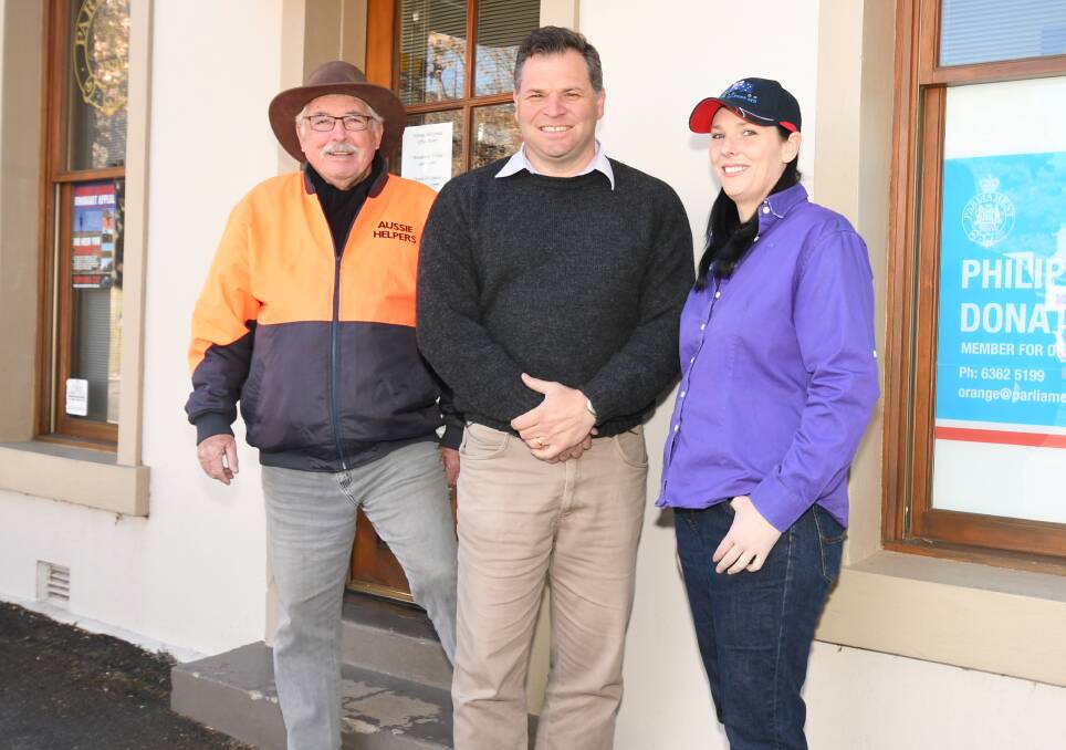CALL OUT: Aussie Helper founder Brian Egan with member for Orange Philip Donato and Krystal Haycock. Photo: CARLA FREEDMAN 0723cffarmers3