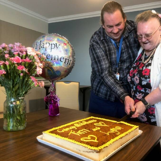 LOVED UP: Benjamin Short Grove residents Tim Johnson and Lynn Marks cut their engagement cake. Photo: SUPPLIED.