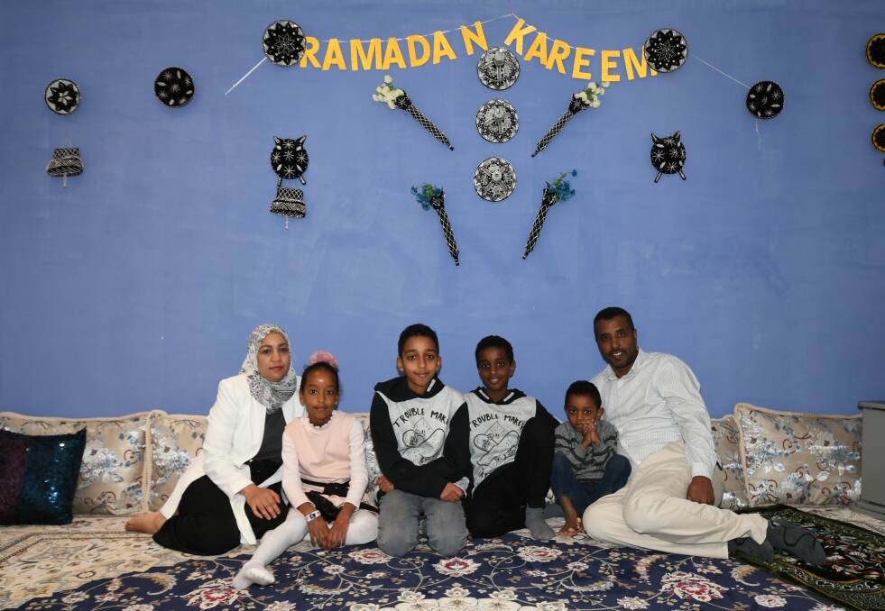 RAMADAN READY: Yasmin Yusuf, Armina, Yusuf, Naeem, Mohammed and Salahadin Khairo ready to break the fast for the evening. Photo: CARLA FREEDMAN 0528cfram1