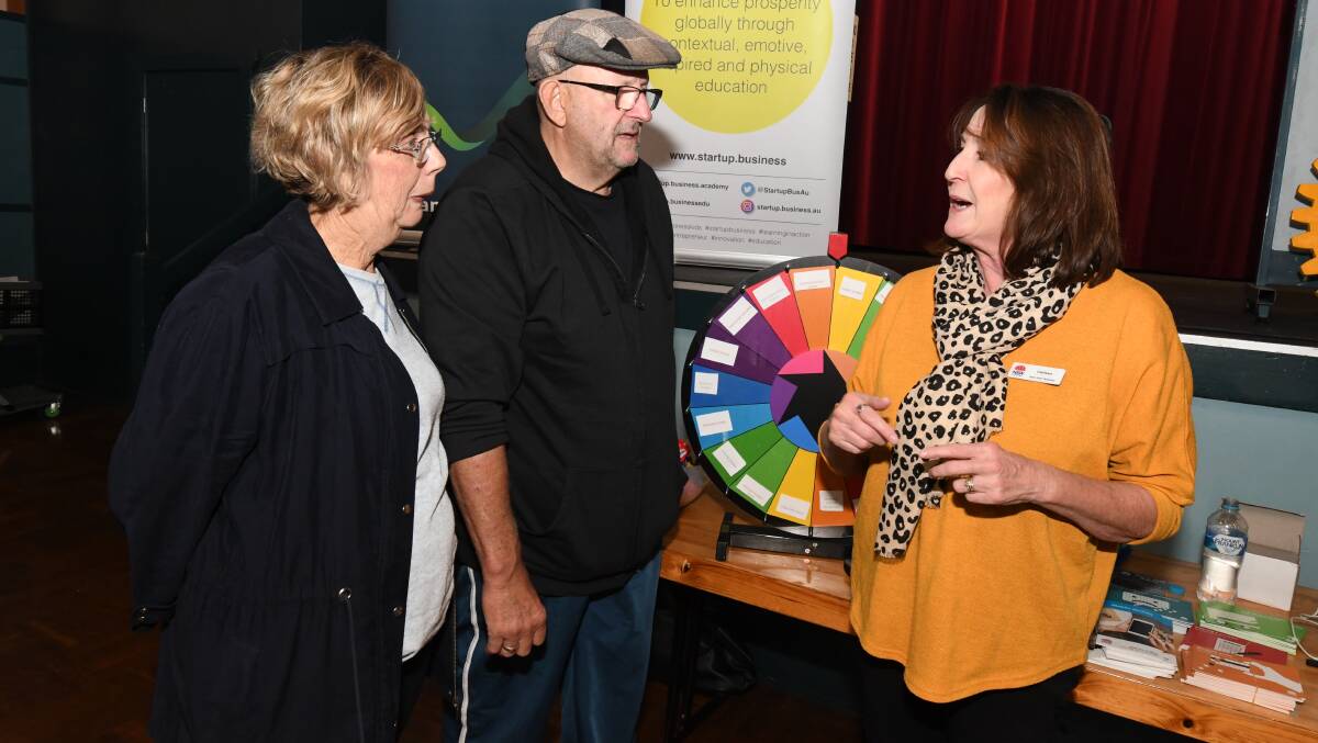SCAM SMART: Barbara and Ron Parry pick up some tips from NSW Fair Trading's Carleen McConnell. Photo: JUDE KEOGH 0515jkexpo8