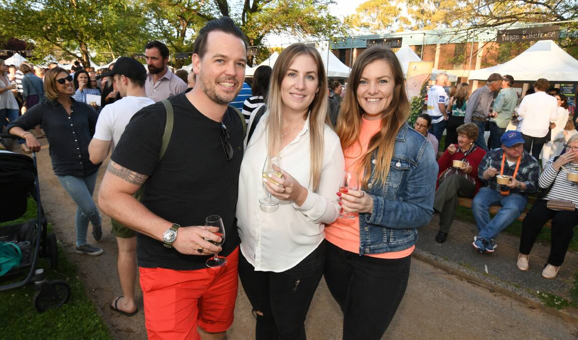 NIGHT MARKET: Johan Overa, Alicia and Melanie Hodge made the most of the warm Spring evening on Friday with dinner at Robertson Park. Photo: JUDE KEOGH 1019jknight10
