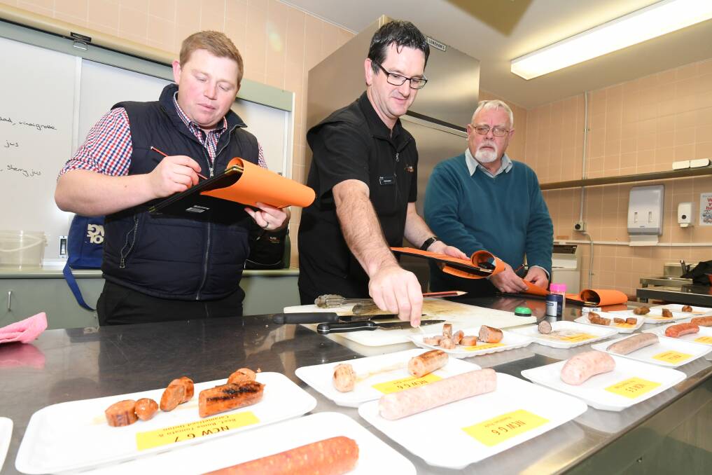 TASTE TEST: Glenn Atkinson, Martin Bennett, John Finlayson had the hard task of judging the region's best sausage. Photo: JUDE KEOGH 0816jksnag2