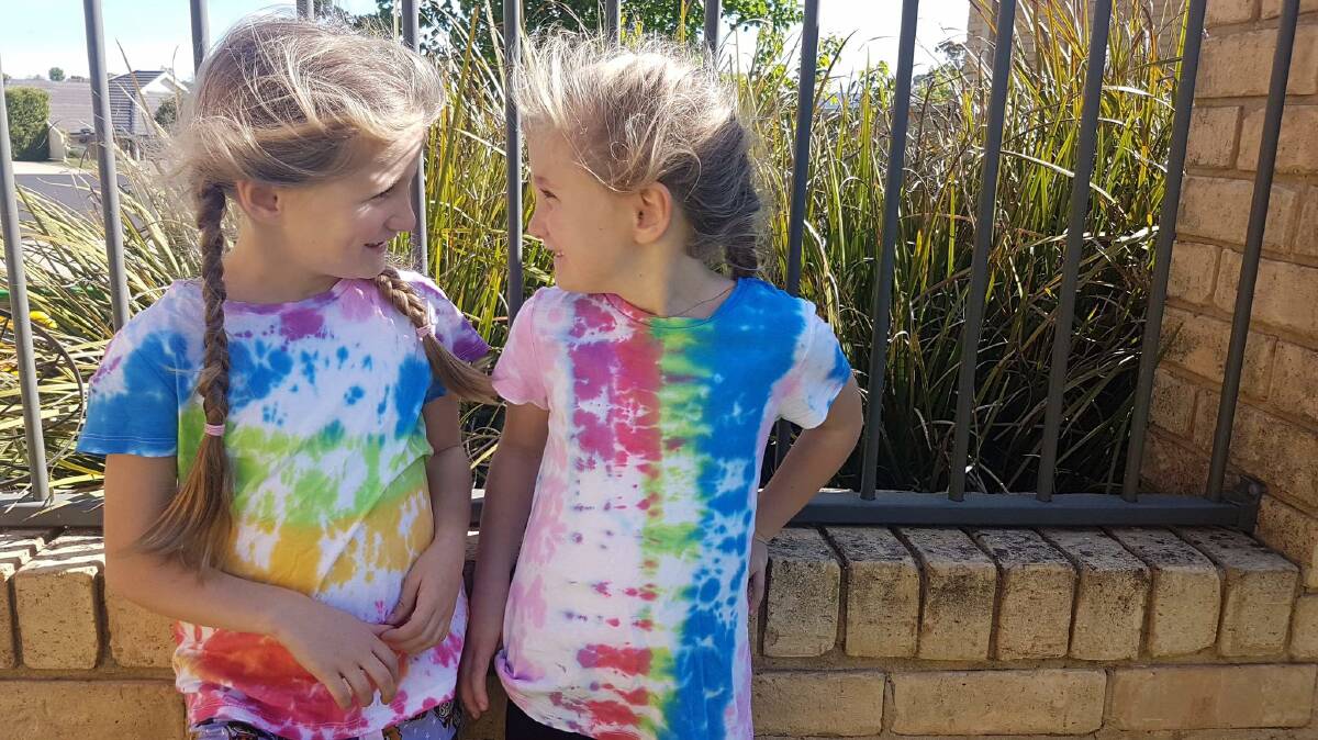 TIE DYE: Kate and Mikaili Elliott rock their homemade tie dye tees. Photo: Facebook: @theclevernessartschool