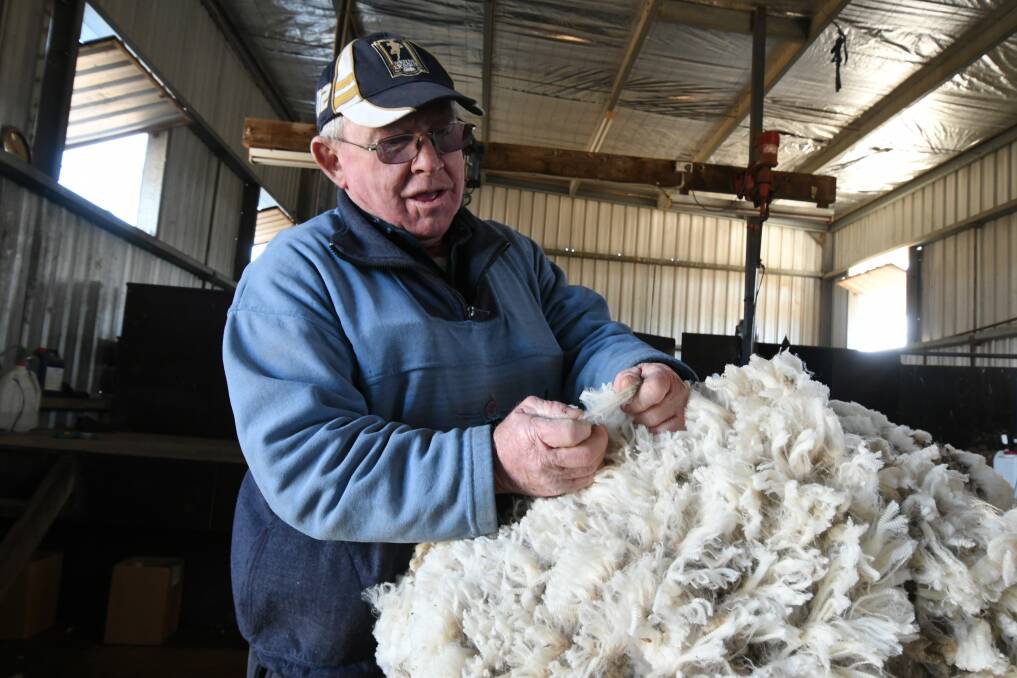 PRICE HIKE: Record-breaking wool prices have given sheep farmers including Errol ‘Badger’ Babbage reason to celebrate this month. Photo: JUDE KEOGH 0717jkwool6