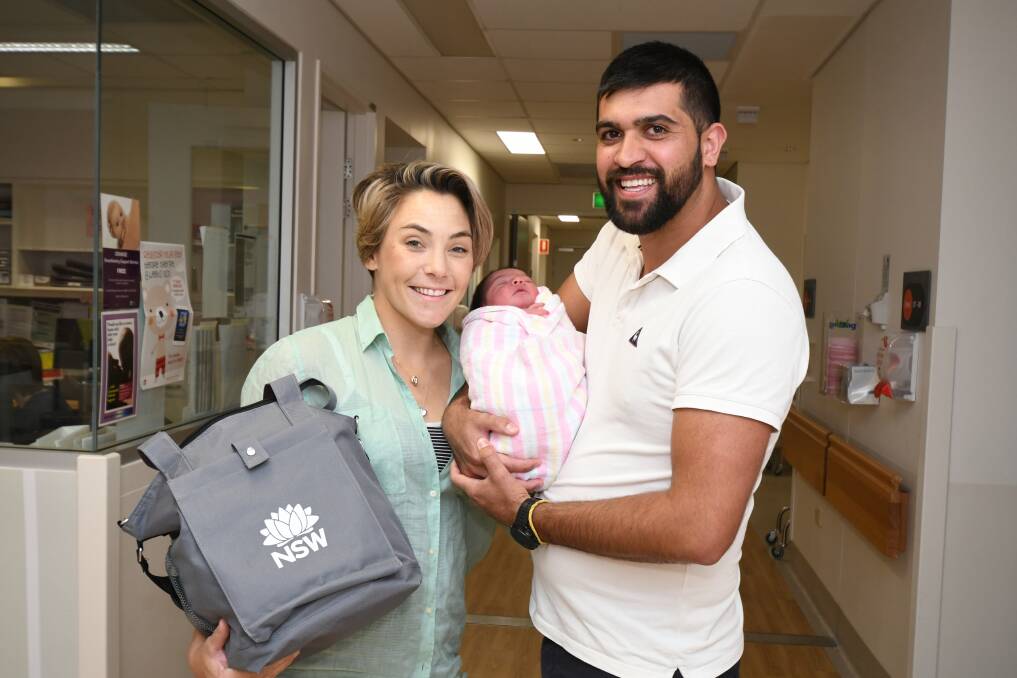 BABY PACK: Lydia Rosser, Josephine Smith and Keith Smith left hospital with a care package courtesy of the government. Photo: JUDE KEOGH