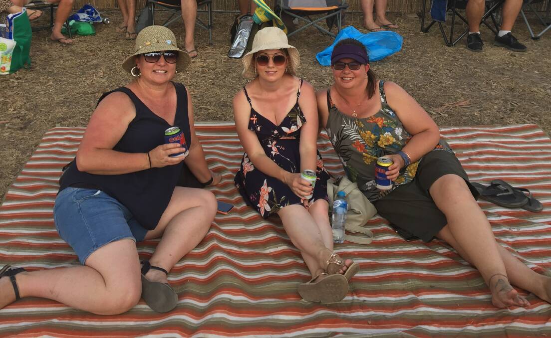 HEIFER STATION: Kim Roughley, Renee Rochester and Belinda Houghton spread out the picnic rug in preparation for Cold Chisel. Photo: ALEX CROWE