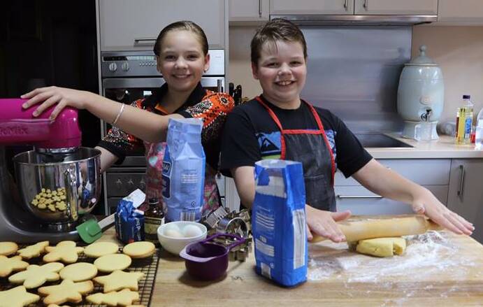 COOKIE TIME: Jorjia and Jackson Kennewell were busy in the kitchen this week to prepare biscuits to decorate during the workshop on Friday. Photo: supplied.