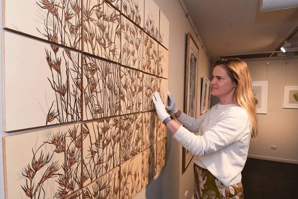 ART SHOW: Cecilie Knowles preparing the Orange Regional Gallery for Continuum's opening this week. Photo: JUDE KEOGH