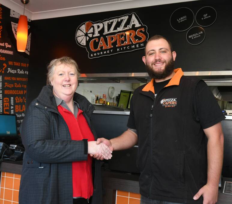 PIZZA PALS: Toni Parker said Housing Plus was grateful to receive the call from Sam Livingstone on Monday night offering a donation of excess pizzas. Photo: JUDE KEOGH 0717jkcapers2