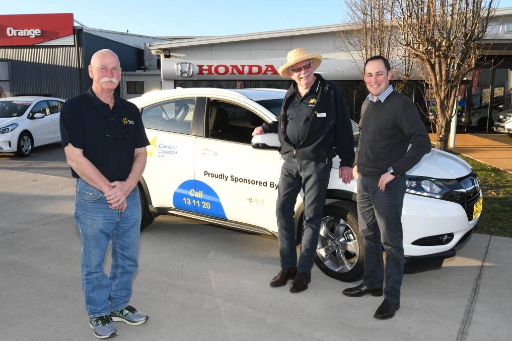 NEW WHEELS: Volunteer drivers for Cancer Council Phil Sturt and Graham Priddle with Honda Sales Manager Jackson Robbins. Photo: JUDE KEOGH 0725jkhonda1