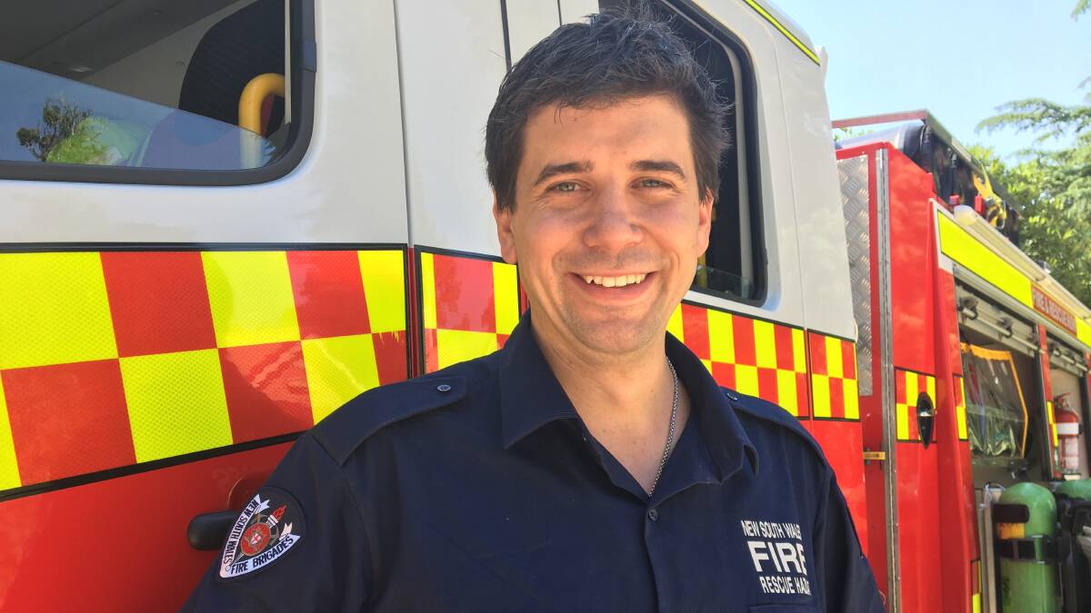 AUSSIE HERO: Fireman Harry Bishop was at Cook Park on Saturday to give children a chance to see inside a real fire truck. Photo: ALEX CROWE 0126acfirey