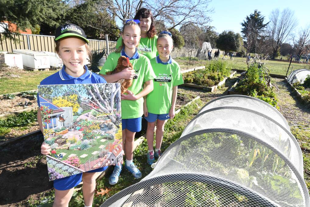 SUSTAINABLE STAMPS: Calare Public School students Eloise Harrison, Marley Aplin and Malia Nicol were in the garden with Australia Post's Alison Strudwick to celebrate Stamp Collecting Month . Photo: JUDE KEOGH