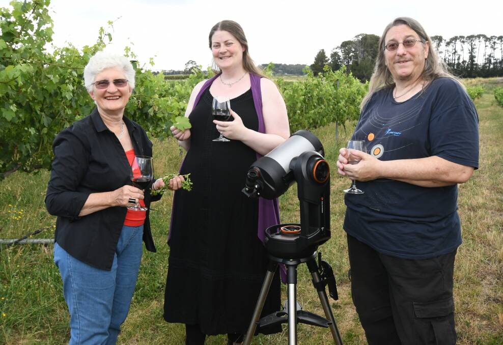 STAR GUIDES: Dindima Wines Lee Bell with astronomers Tina and Trevor Leaman at the Cargo Road vineyard. Photo: JUDE KEOGH 0103jkstars2