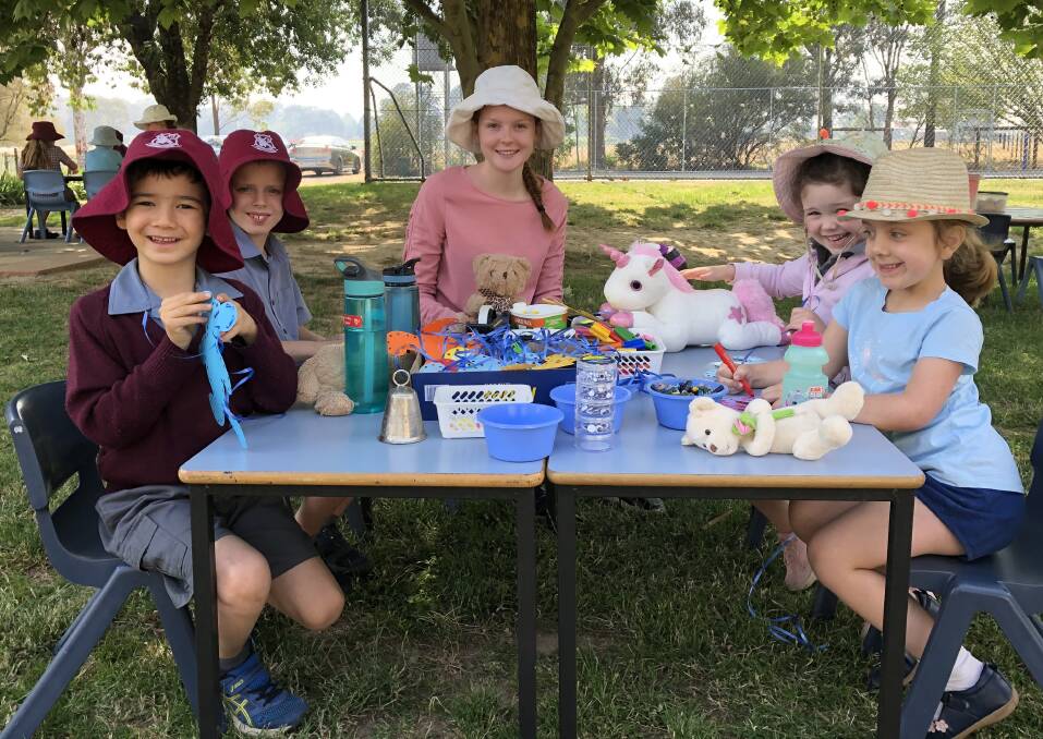PICNIC TIME: Timothy Napier, Liam George, university student Eilish Cook, Esme Squires and Grace Luke at the teddy bears picnic at Borenore this week. Photo: SUPPLIED