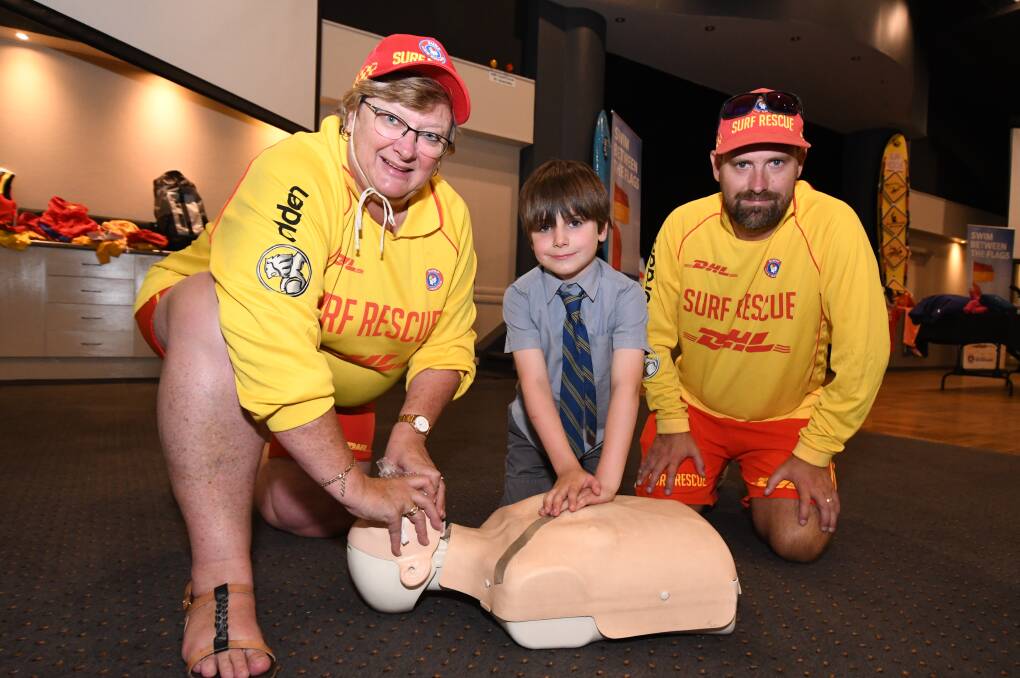 BEACH SAFETY: Kim Rayner from Port Maquarie and tacking Point Surf Lifesaving Clubs, Orange Bush Nipper Hayden Calder and James Worrall from Fingal Beach Surf Lifesaving Club. Photo: JUDE KEOGH