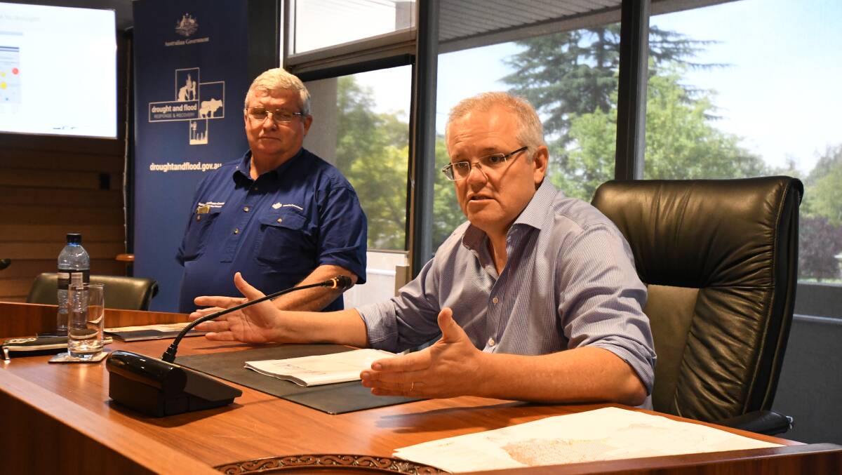 MISSED OUT: Head of drought and flood agency Shane Stone with Prime Minister Scott Morrison in the Orange City Council chambers on Tuesday. Photo: JUDE KEOGH
