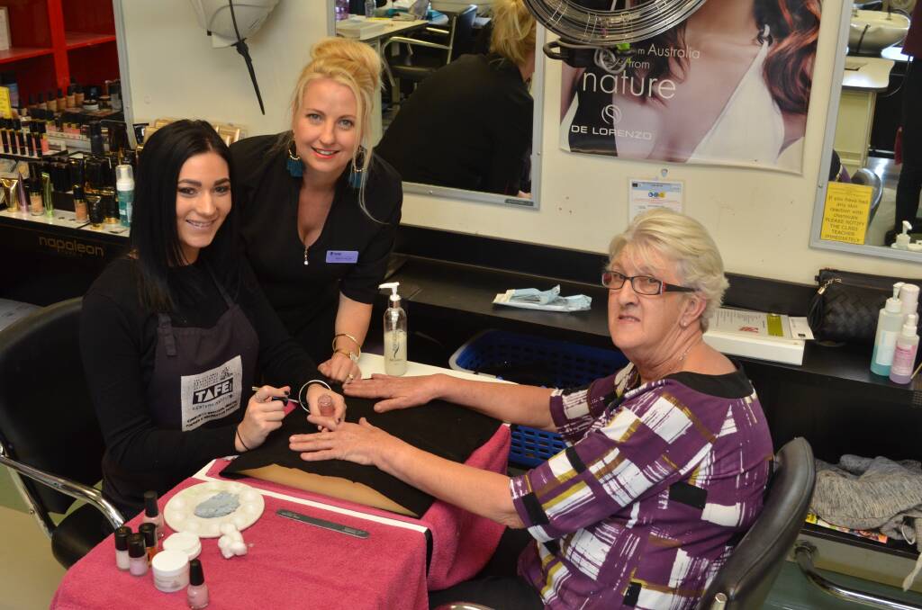 BEAUTY THERAPY: TAFE student Casey Watts received instruction from teacher Rebecca Phillips to provide Jenny Agland with super fresh nails at a very reasonable rate. Photo: ALEX CROWE 051acbeauty1