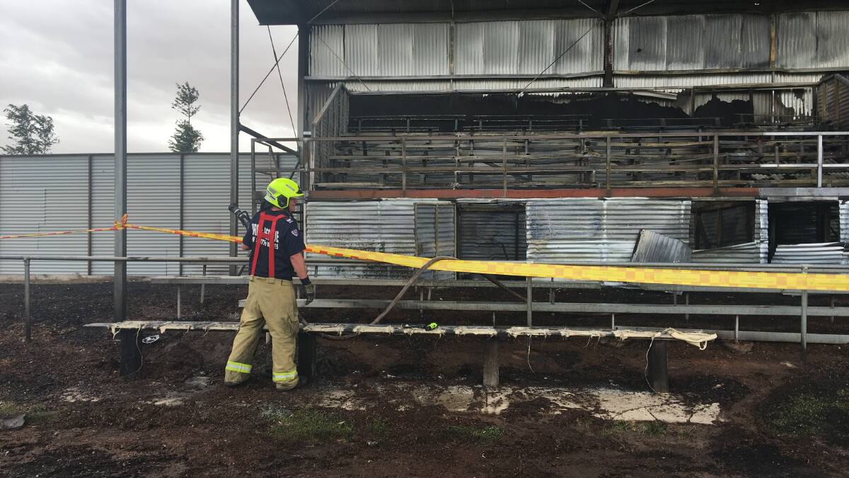 Emergency services clean up after blaze damages grandstand.