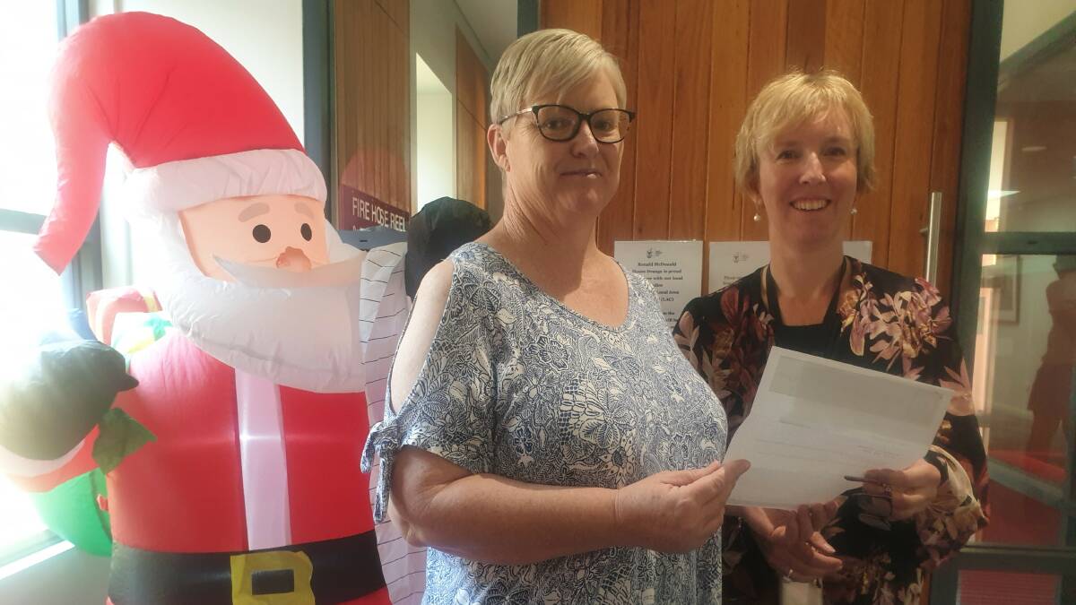 The twins auntie, Danielle Oresic from Blayney hands a final donation to executive officer of Ronald McDonald House Orange, Rebecca Walsh. Photo: SUPPLIED