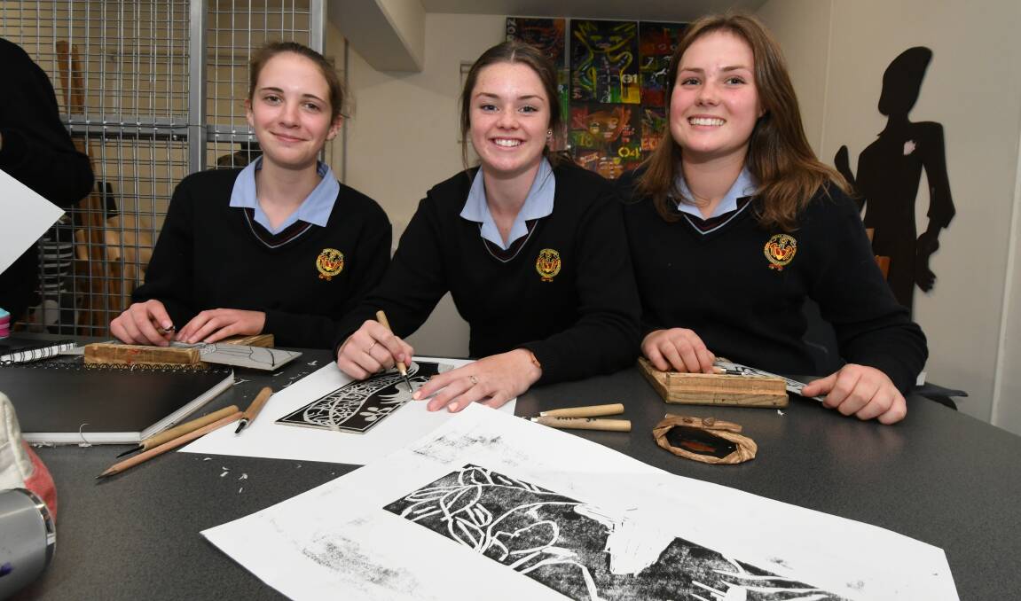 YOUNG ARTISTS: Lillian Quick, Ella Barrett and Abby Dean collaborated for the Waste to Art competition on display at the library. Photo: JUDE KEOGH: 0530jkwaste3