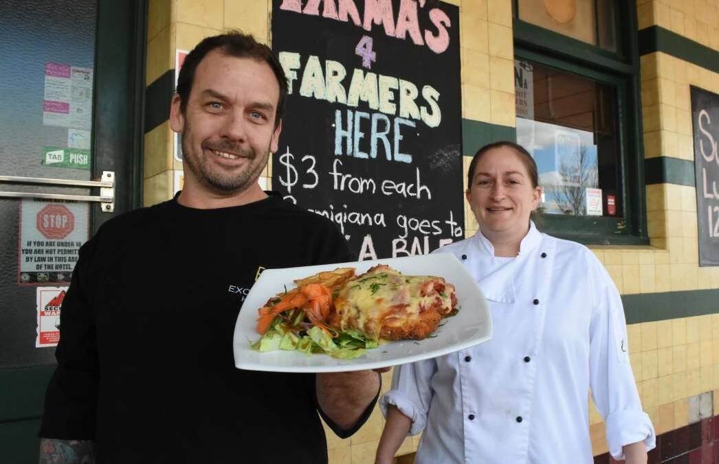 BLAYNEY PARMI: Marty Russell and Kathryn Cumberland with one of the chicken parmas which will raise money to help farmers in drought. Photo: Mark Logan.