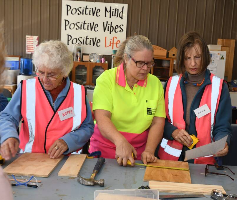 WOMEN'S WORK: Facilitator Kathy Sharpe goes over the basics before the power tools come out with Fi Shewring and Carol Hartin. Photo: JUDE KEOGH 0517jkshed7