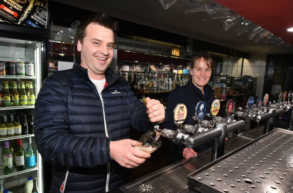 BEER MONEY: The Ophir Hotel owner Tim Ireson and Debbie Wright get set for a busy weekend serving the community. Photo: JUDE KEOGH 0822jkbeer1