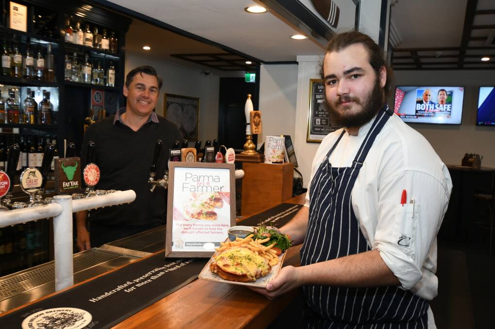 PARMA RELIEF: The Lord Anson Manager Richie Curry and Chef Jack Mills do their bit for farmers with delicious crumbed chicken. Photo: JUDE KEOGH 0822jkparma1