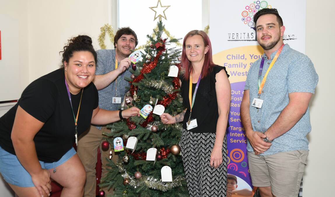 WISHING TREE: Haylee Lepaio, Ty Mostyn, Erin Hogben and Jordan Collins want help to give clients a great Christmas. Photo: CARLA FREEDMAN