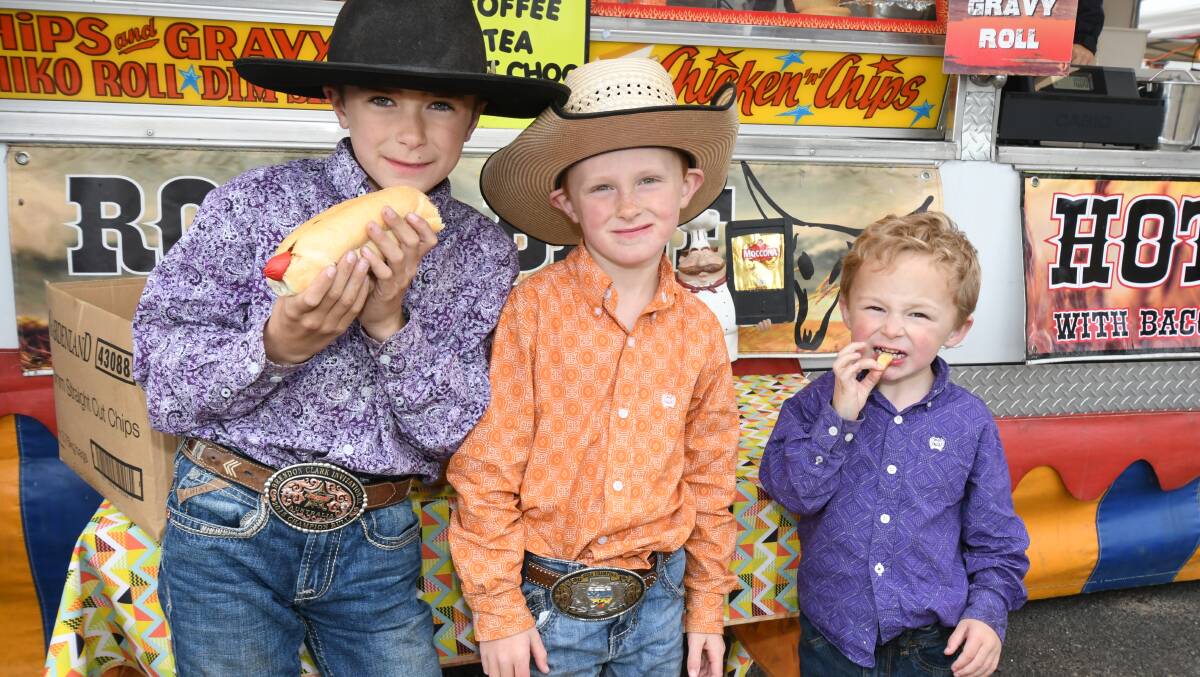 RODEO: Dylan, Layne and Wyatt Besant had a snack break at the 2018 rodeo. Photo: JUDE KEOGH