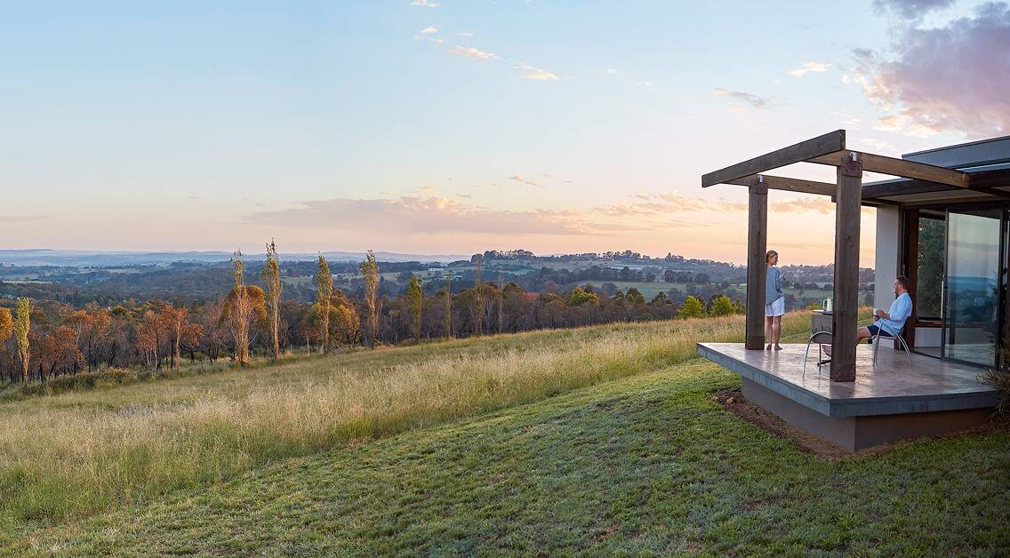 ROOM WITH A VIEW: A couple take in the sunset at Borrodell Vineyard. Photo: SUPPLIED
