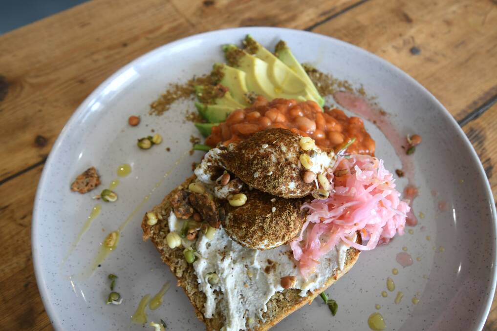 BACON FREE: Grocer and Co's 'Hipster Brunch' consists of quinoa on a slice of gluten-free toast served with a dukkah rolled poached egg, avocado, sprouts, rocket, kraut, cashew cheese and beans. Photo: JUDE KEOGH 0726jkbrunch1