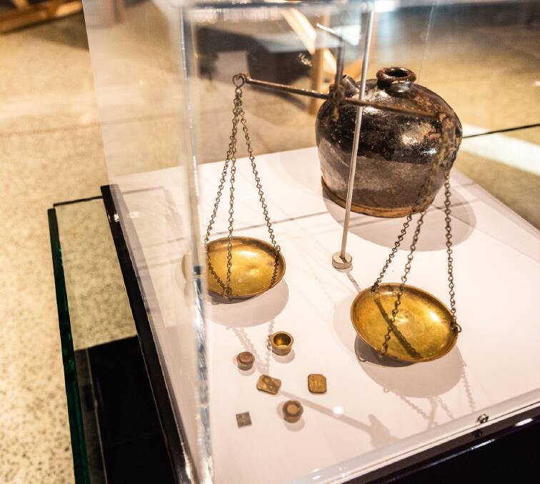 BYGONE ERA: Gold scales used at Ophir and a soy sauce bottle on display in the exhibition Inherit: old and new histories. Photo: Rosie Long Photography