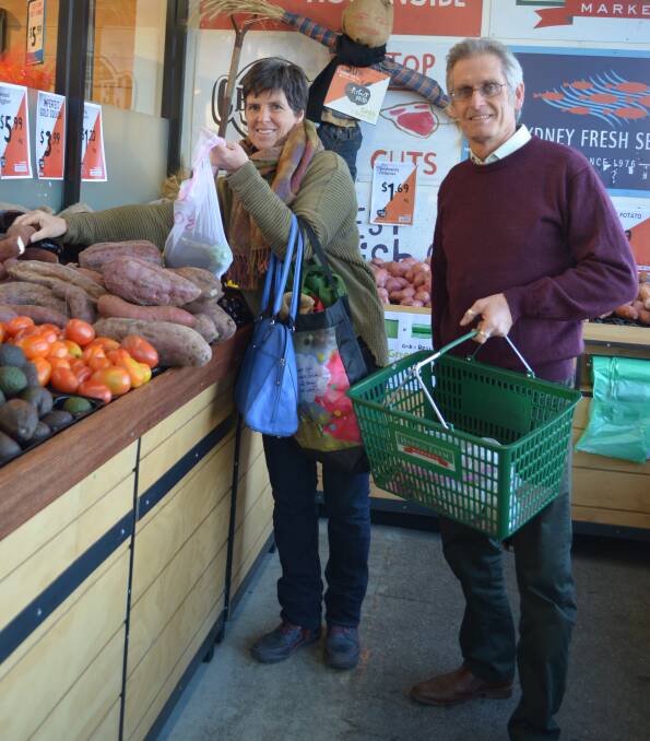 DOING THEIR BIT: Fiona Hawke and Stephen Nugent shopping with their Environmentally Concerned Citizens of Orange mesh bags. Photo: CONTRIBUTED