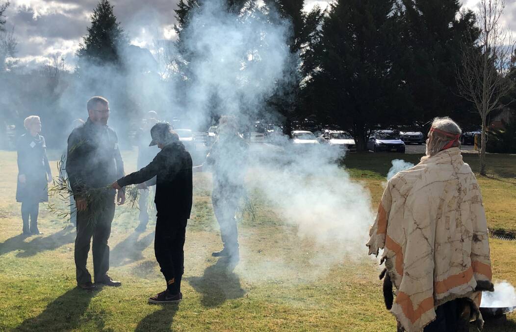 WELCOME: Dr Mathew Johnson, executive director of the Swearer Centre for Public Service at Brown University in the United States, is welcomed to Charles Sturt University by Bathurst Wiradjuri traditional owners in a smoke ceremony. Photo: SUPPLIED
