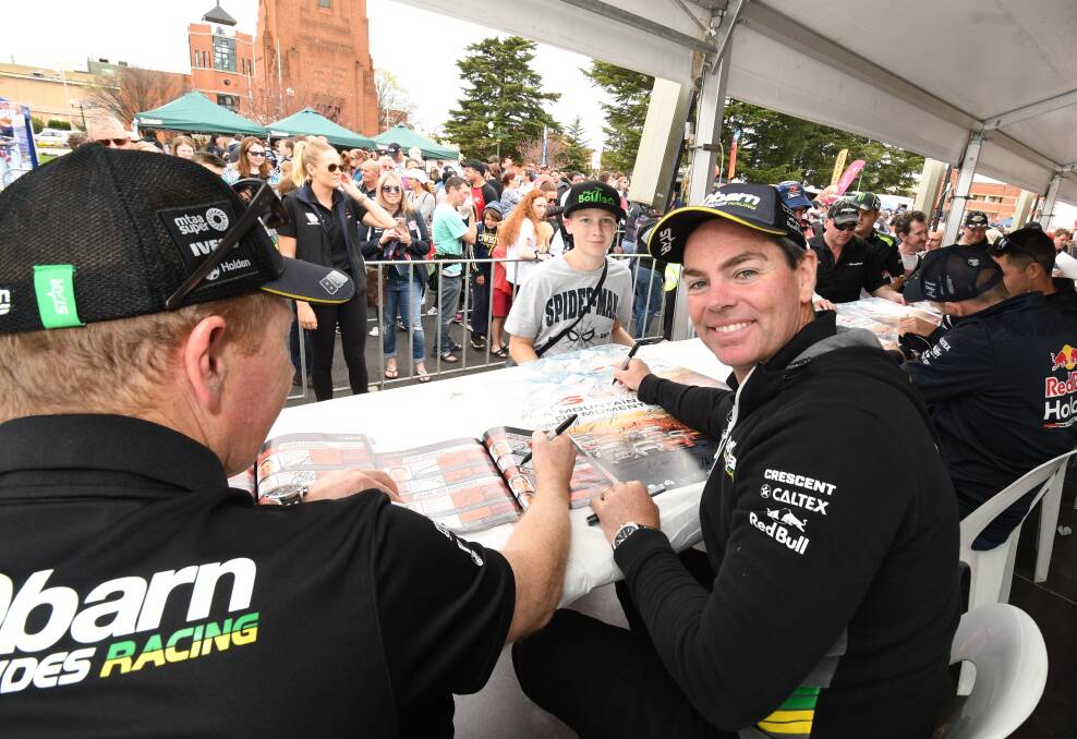 RACING LEGEND: Driver Craig Lowndes signs for fans at the Bathurst 1000. Photo: SUPPLIED.