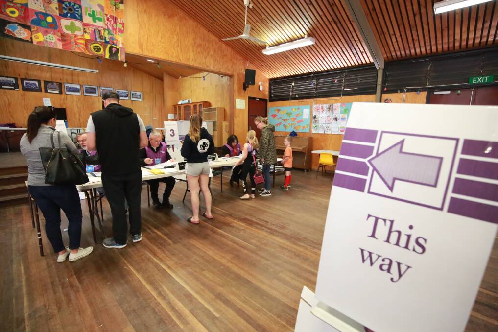 MAKING IT COUNT: Voters getting their names marked off the electoral roll at Eglinton Public School on Saturday. Photo: PHIL BLATCH
