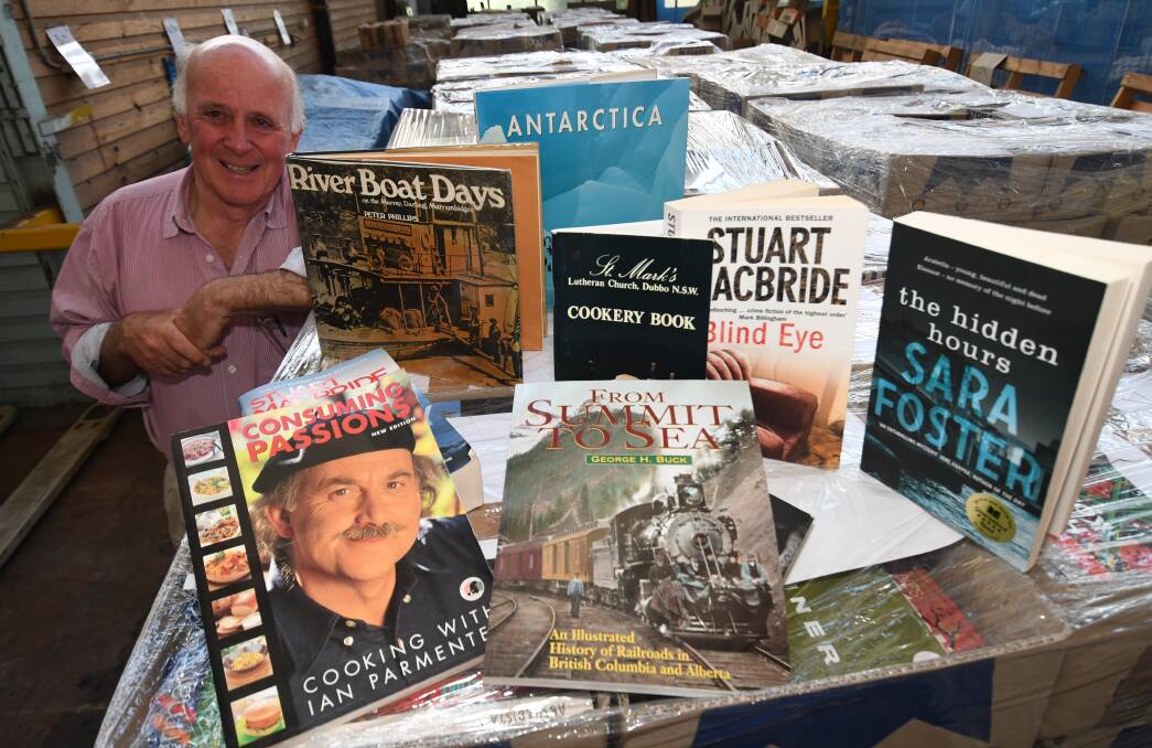 GRAB A BARGAIN: Lifeline Central West executive director Alex Ferguson, showing off some of the 24,000 books that are for sale. Photo: CHRIS SEABROOK 101518cbookfr1 