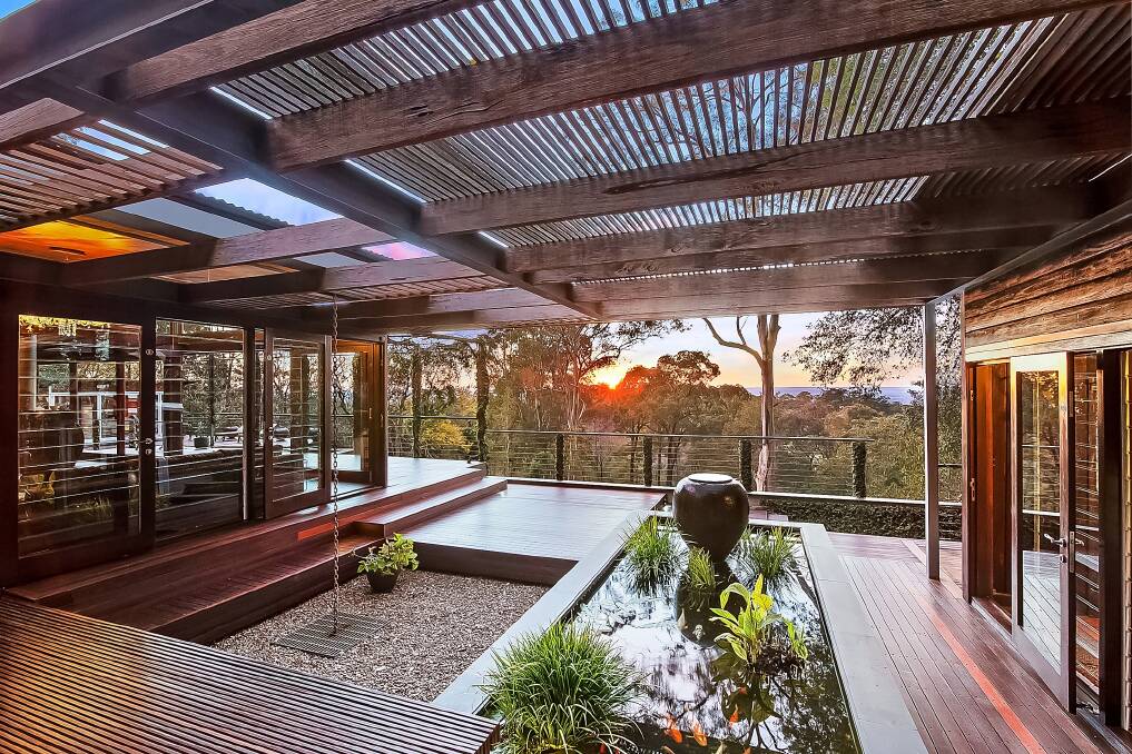 VIEWS FOR MILES: Nestled into the dense bushland of Bowen Mountain, the house is set on a steep block in an elevated rural region adjoining the Blue Mountains National Park. Photo: Murray Fredericks