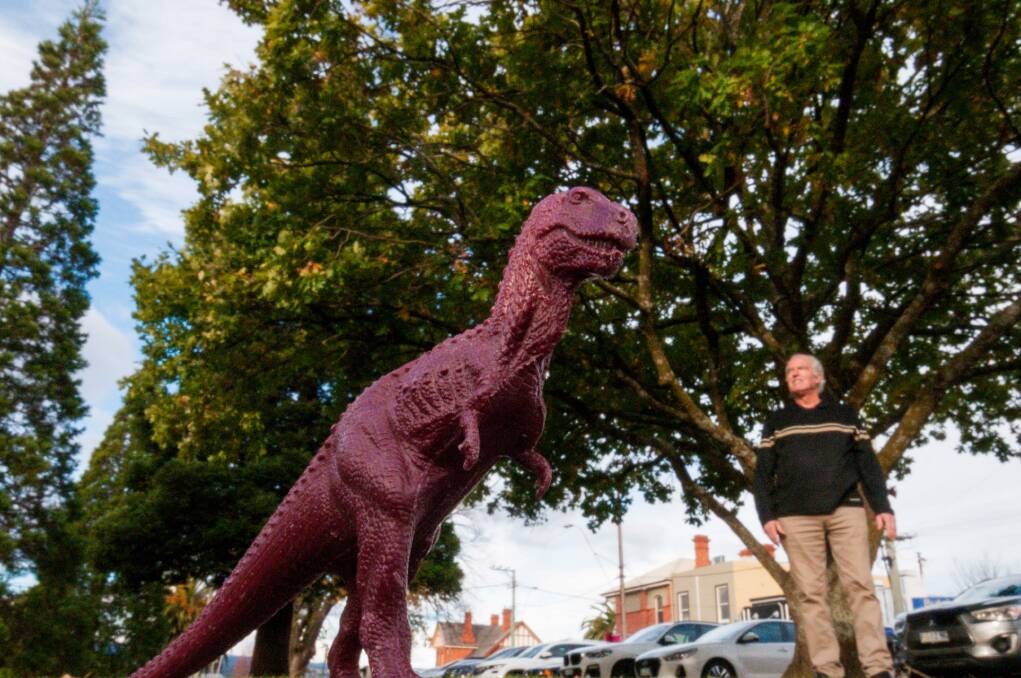 Allan Limb, also known as the "dinosaur man", with a model of the T-Rex. Picture: Phillip Biggs 