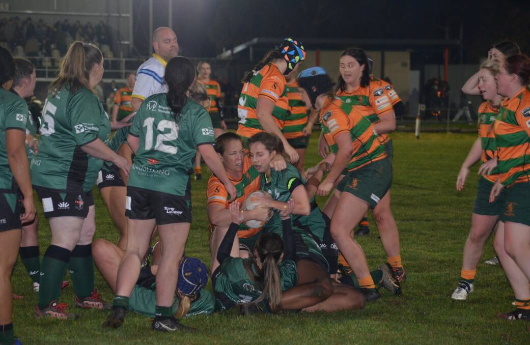 PHYSICAL: Orange City and Orange Emus derby match had plenty of big hits and collisions. Photo: LACHLAN HARPER 