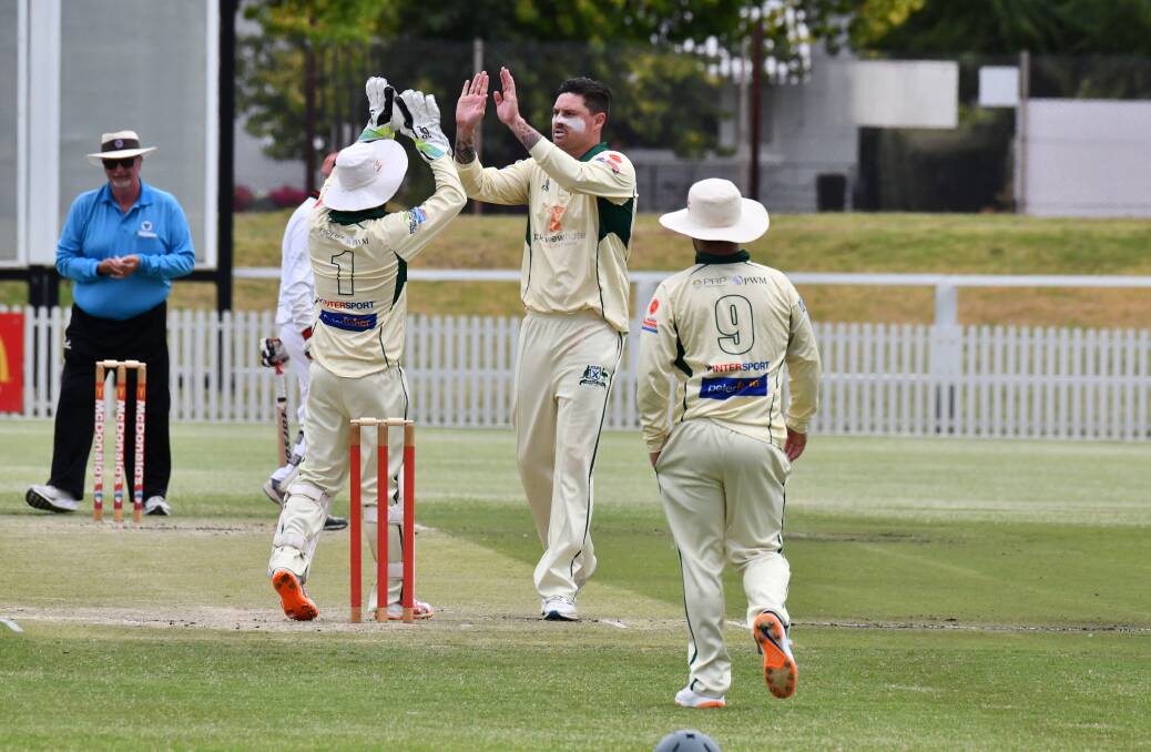 Ed Morrish celebrates with Steve Sharp after a wicket against Centrals. Picture by Jude Keogh 