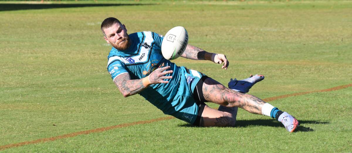FULL OF EFFORT: Josh Dugan attempts to tap the ball back into field. Photo: JUDE KEOGH