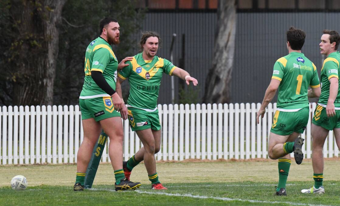 YOU'RE THE MAN: Robbie Mortimer points to Lachie Munro after the fullback set him up for a try. Photo: JUDE KEOGH