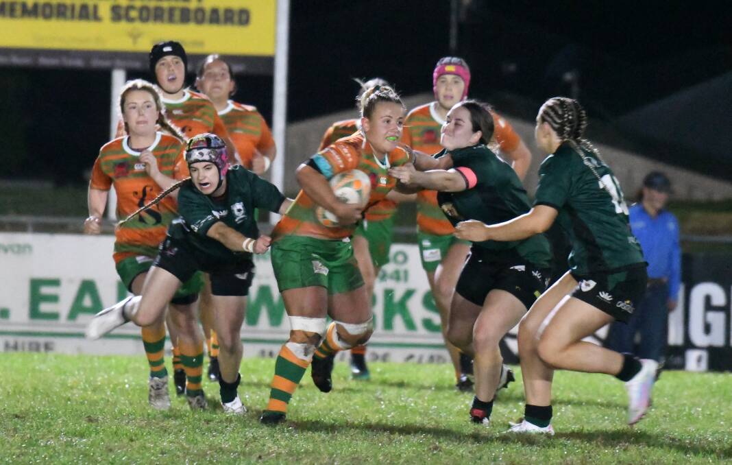 DON'T ARGUE: Holly Jones looks to palm off Orange Emus defenders last year. Photo: JUDE KEOGH