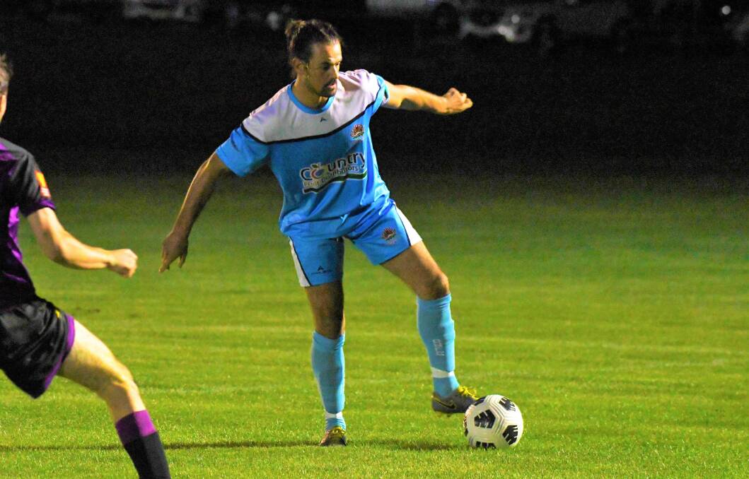 DISAPPOINTING: Waratahs' defender Niall Gibb looks to maintain possession in his side's 2-2 draw with Parkes Cobras. Photo: CARLA FREEDMAN
