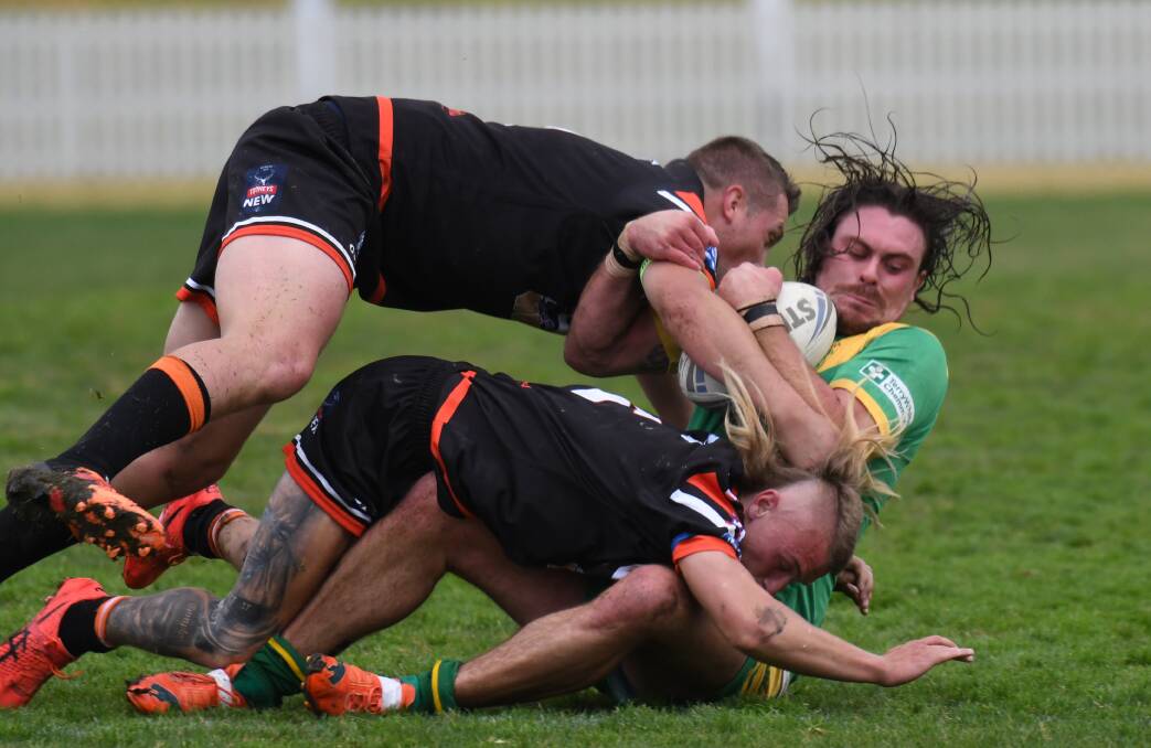 ALL IN: Lithgow's defence tackles Robbie Mortimer. Photo: CARLA FREEDMAN 