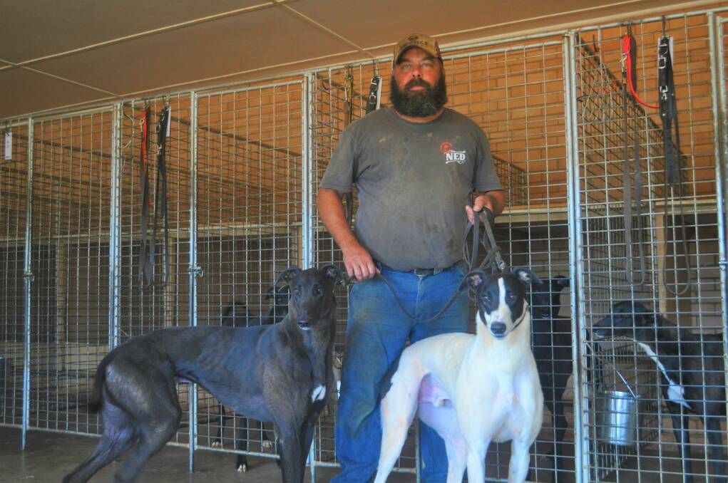 Clergate-based greyhound trainer and breeder David Pringle with his dogs Mo and Ace. Picture by Lachlan Harper 