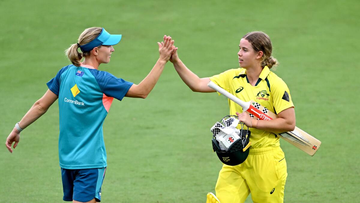Meg Lanning and Phoebe Litchfield hi-five after Australia's win. Photo by Bradley Kanaris/Getty Images
